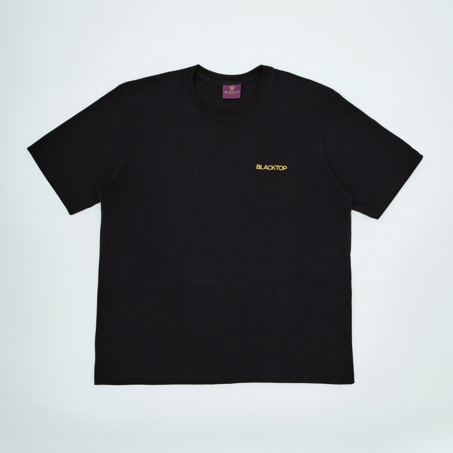 Black t-shirt with 'BLACKTOP' logo on a light gray background