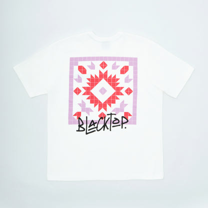 White t-shirt with a geometric pattern and 'Blacktop' text on a light gray background