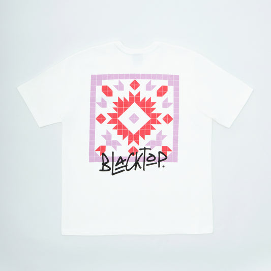 White t-shirt with a geometric pattern and 'Blacktop' text on a light gray background