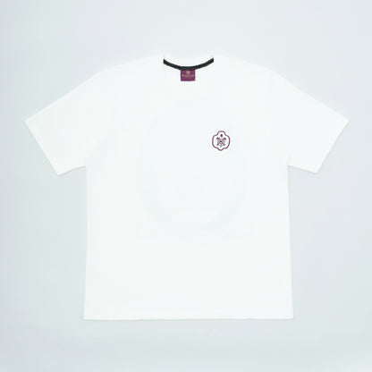 White t-shirt with a small logo on a light gray background
