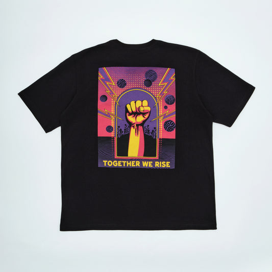 Black t-shirt with a colorful graphic of a raised fist and 'Together We Rise' text on a light gray background